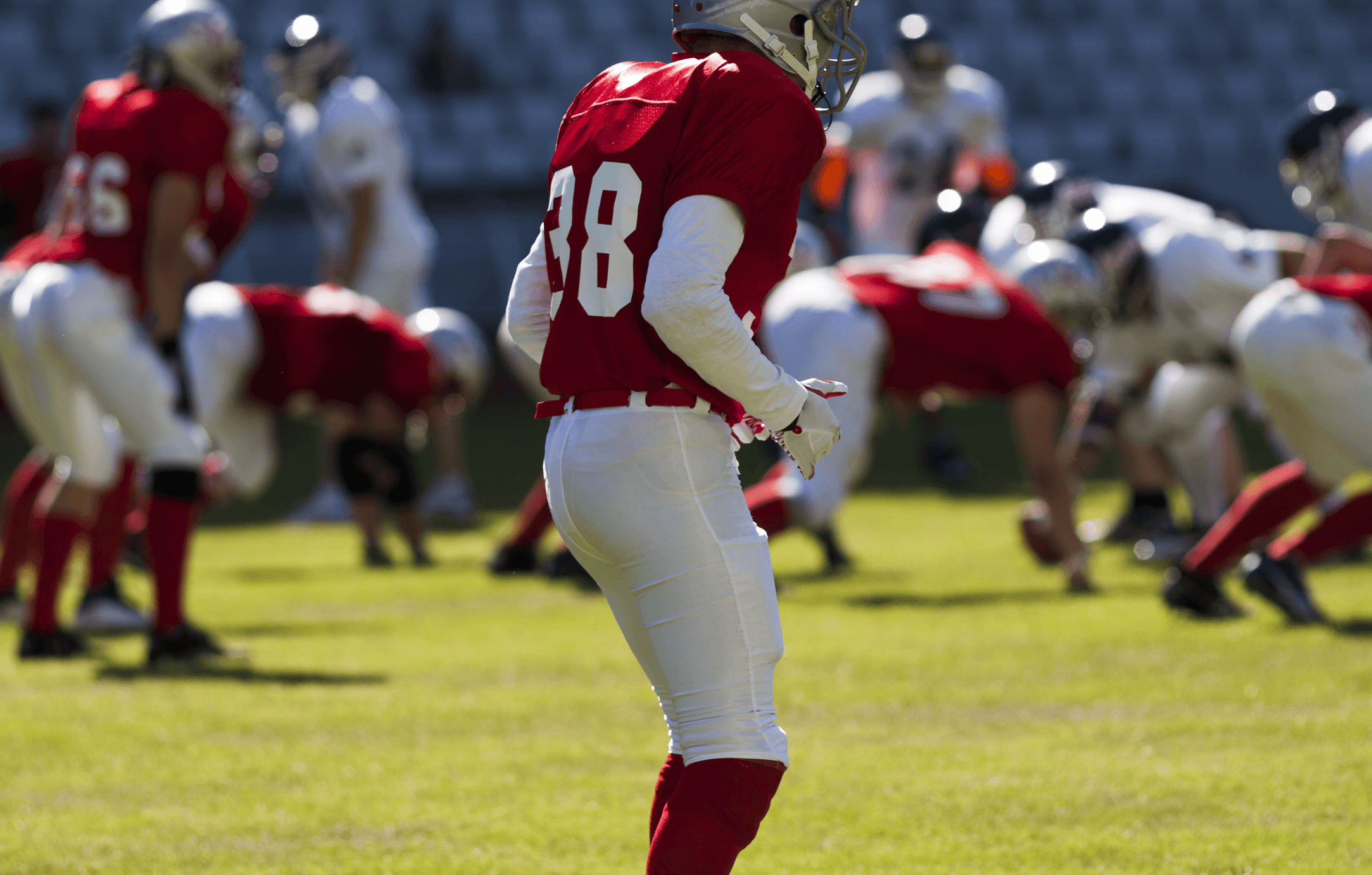 Black and gray image of an American football player on the field